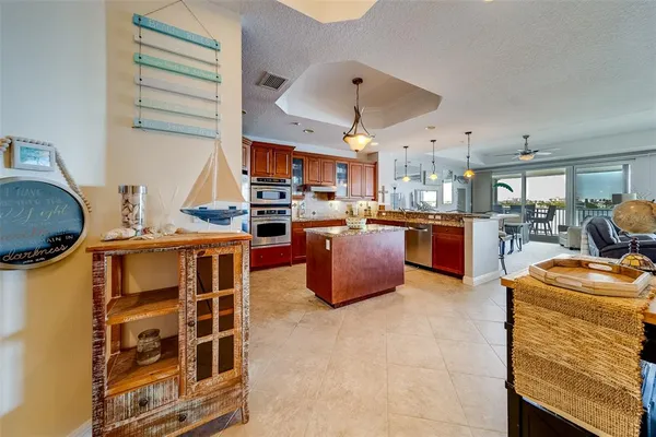 a large kitchen with stainless steel appliances granite countertop a stove refrigerator and a sink