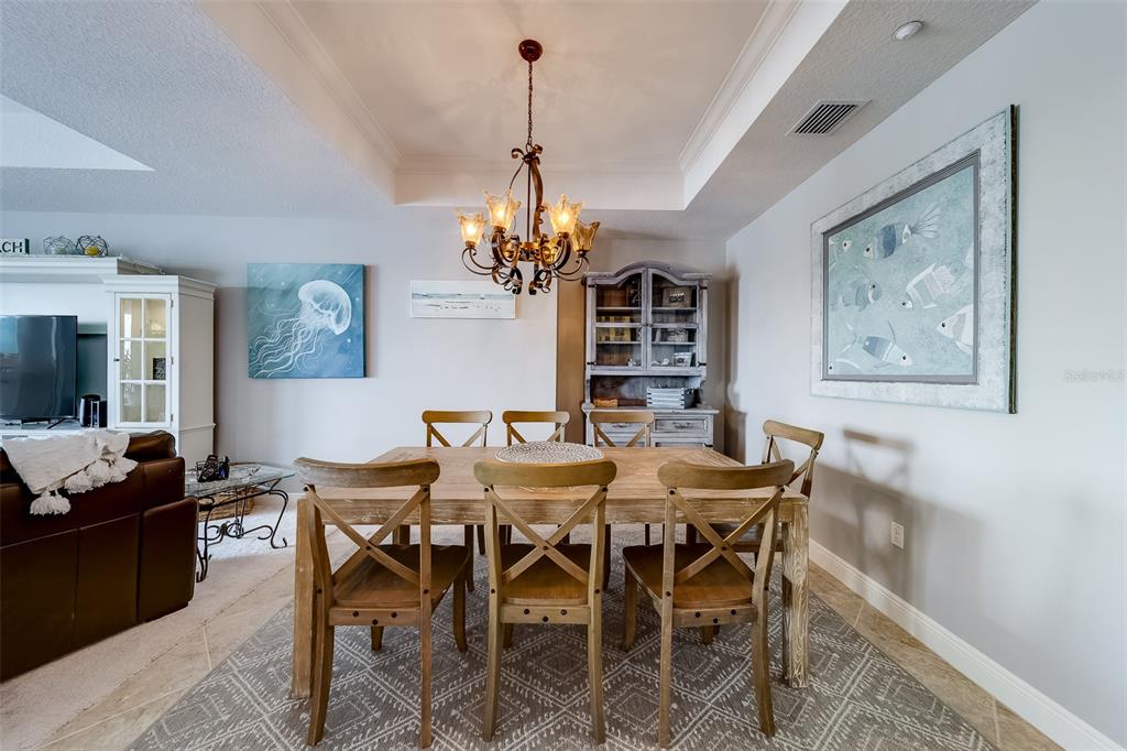 17745 Gulf Boulevard, Unit 303 Redington Shores, FL 33708 - Photo 20 of 83 a view of a dining room with furniture and chandelier