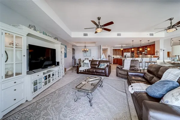 a large kitchen with stainless steel appliances kitchen island granite countertop a large counter top a sink a stove and a wooden floors