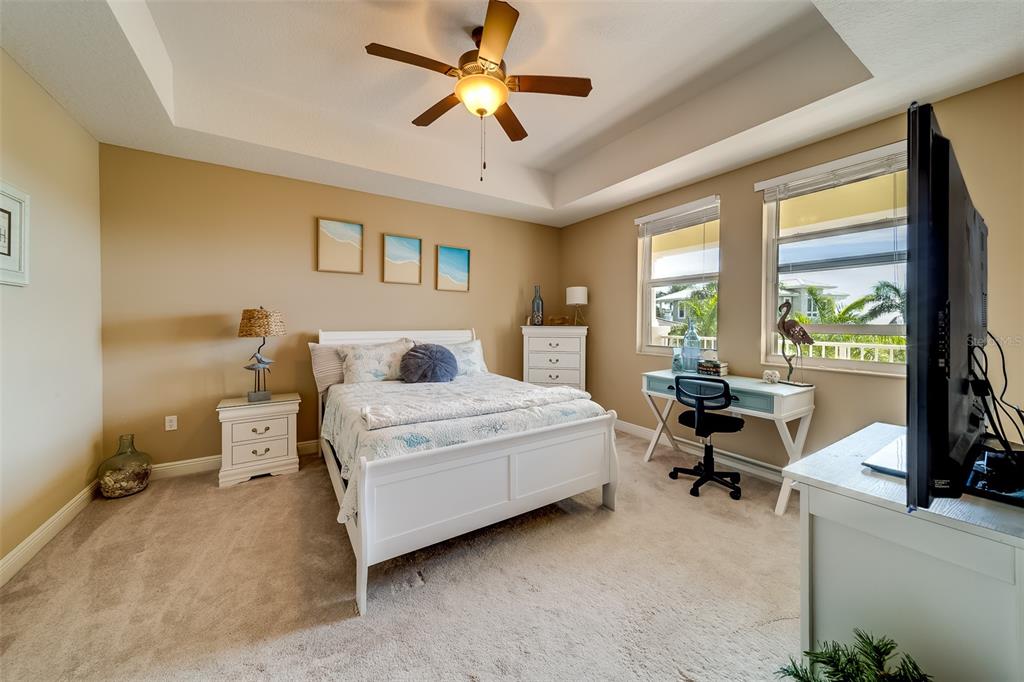 17745 Gulf Boulevard, Unit 303 Redington Shores, FL 33708 - Photo 41 of 83 a spacious bedroom with a bed and a table in it