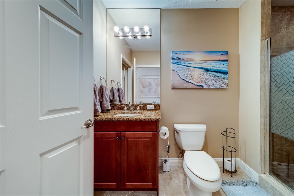 17745 Gulf Boulevard, Unit 303 Redington Shores, FL 33708 - Photo 48 of 83 a bathroom with a toilet a sink and mirror