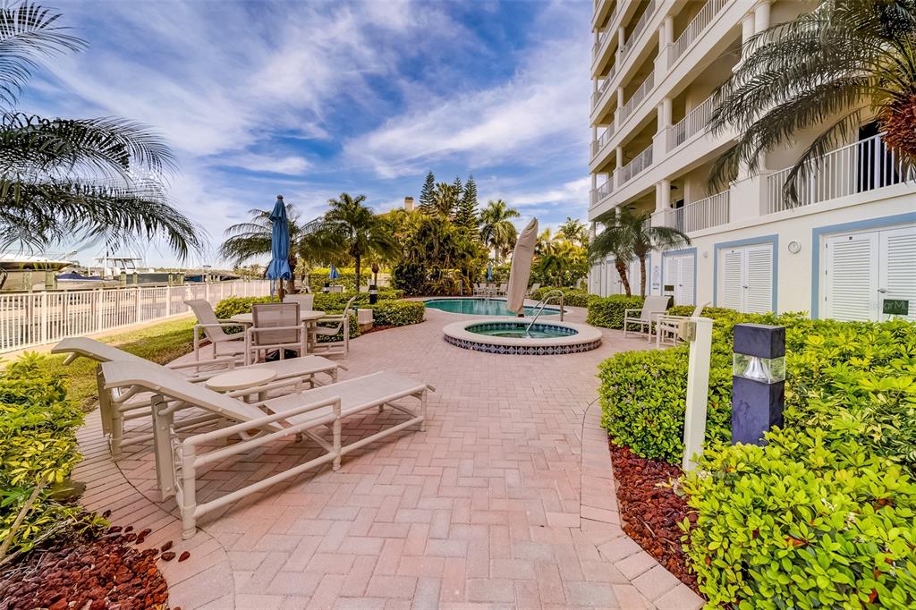 17745 Gulf Boulevard, Unit 303 Redington Shores, FL 33708 - Photo 62 of 83 a view of a swimming pool with outdoor seating and plants