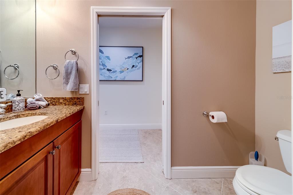 17745 Gulf Boulevard, Unit 303 Redington Shores, FL 33708 - Photo 9 of 83 a bathroom with a granite countertop sink mirror vanity and toilet