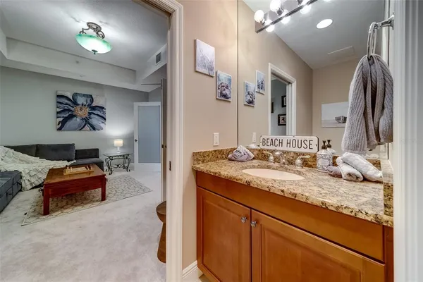 a kitchen with stainless steel appliances granite countertop a refrigerator a sink a stove a kitchen island with chairs and cabinets