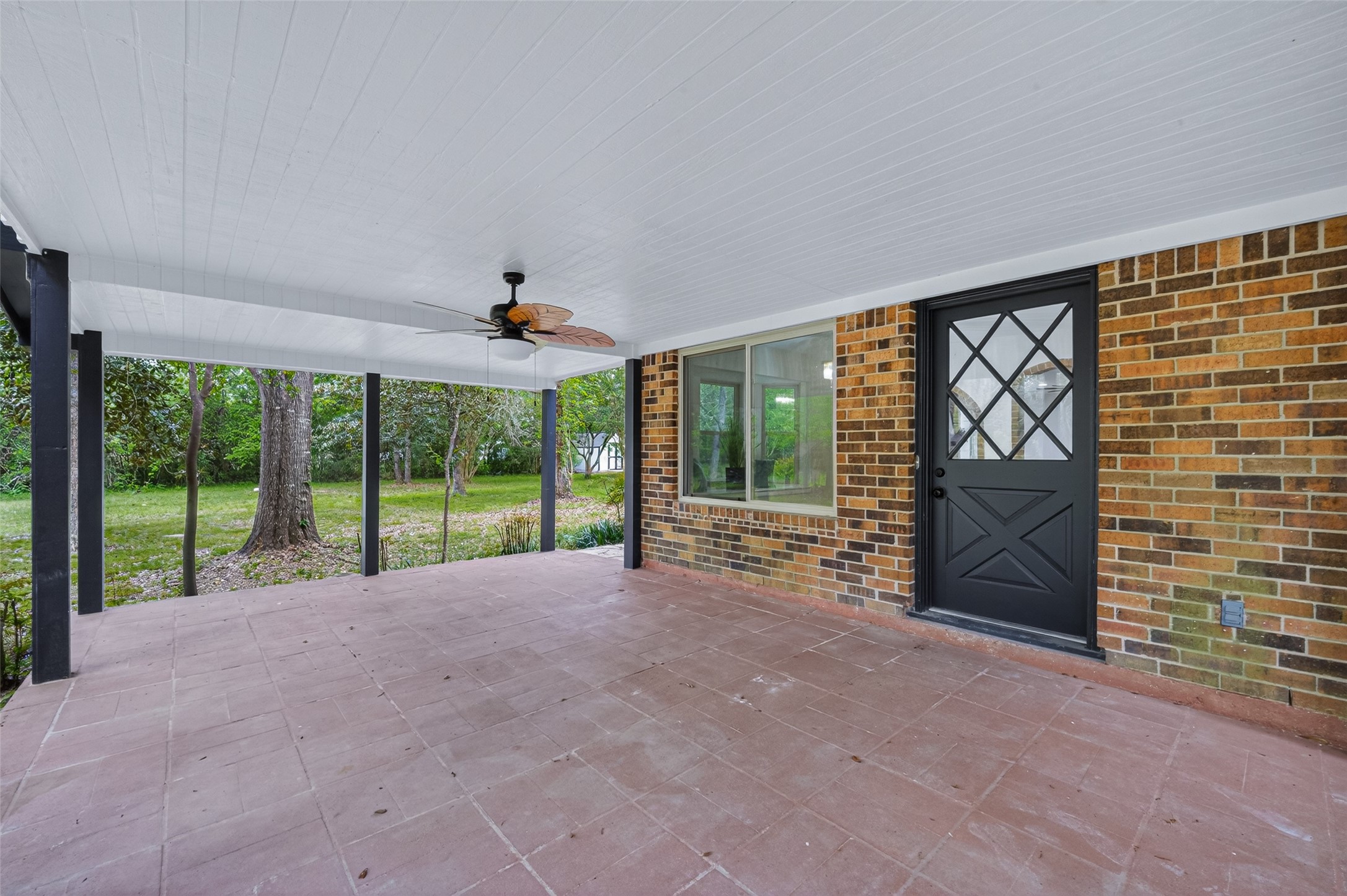 23607 Cardinal Drive Hockley, TX 77447 - Photo 43 of 50 A spacious, covered back patio equipped with a ceiling fan overlooks the verdant grounds, serving as the ultimate venue for summer hosting.