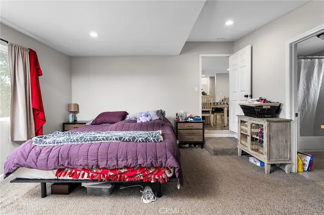 a bedroom with bed and window