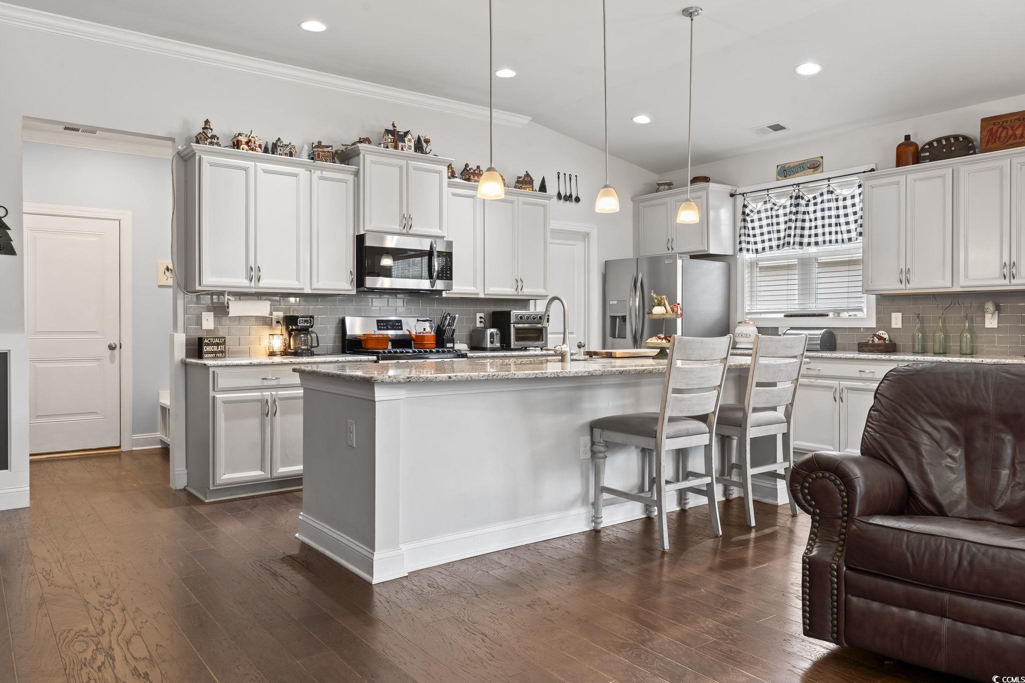144 Bucky Loop Murrells Inlet, SC 29576 - Photo 13 of 40 Kitchen featuring a kitchen island with sink, dark