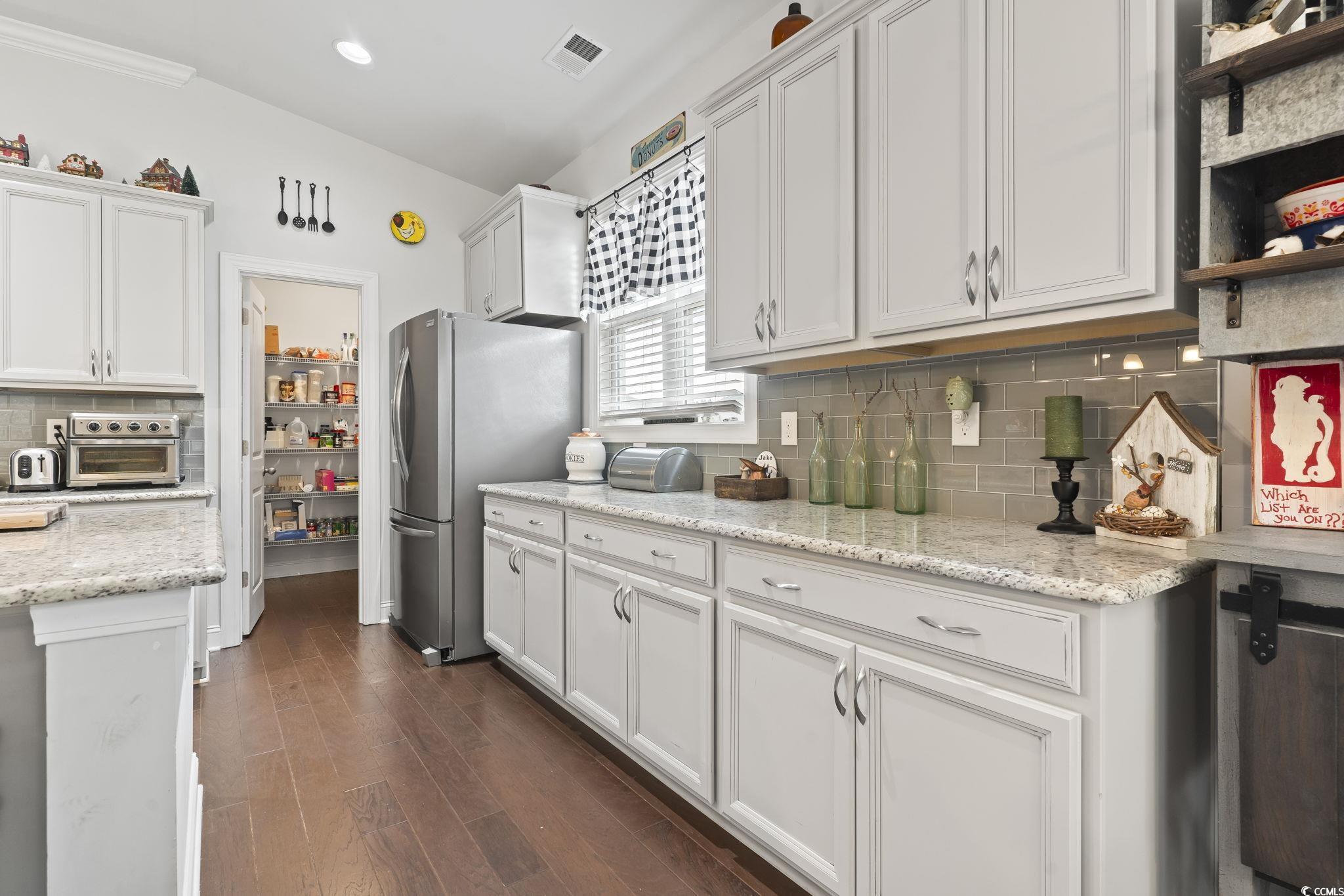 144 Bucky Loop Murrells Inlet, SC 29576 - Photo 14 of 40 Kitchen with backsplash, stainless steel refrigera