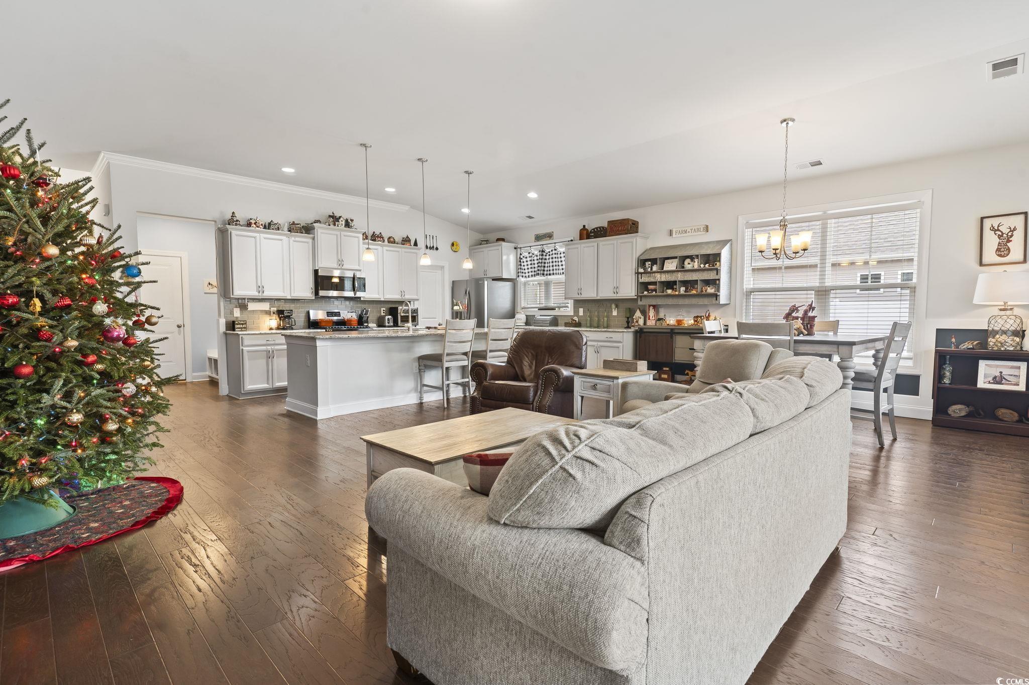 144 Bucky Loop Murrells Inlet, SC 29576 - Photo 21 of 40 Living room featuring a notable chandelier, crown