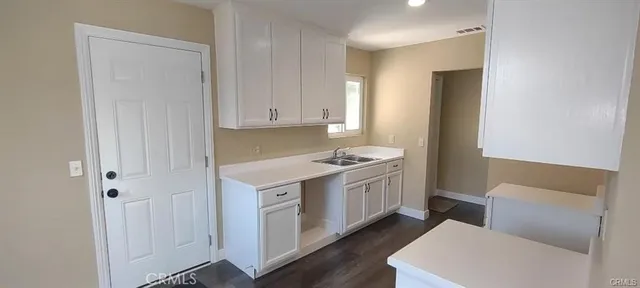 a kitchen with stainless steel appliances granite countertop a white stove top oven and white cabinets