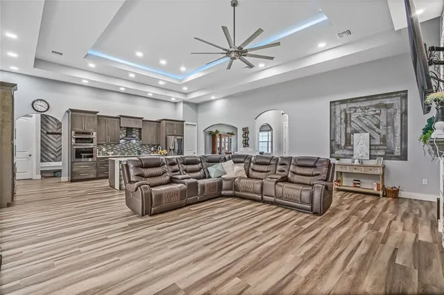 a living room with furniture a large window and a flat screen tv