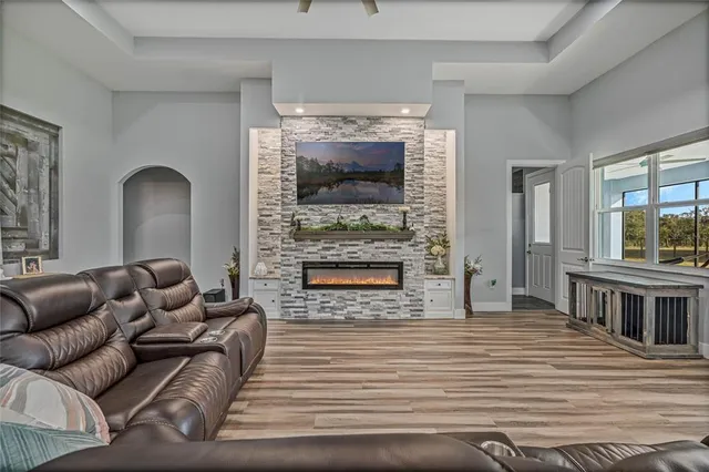 a kitchen with stainless steel appliances kitchen island granite countertop a stove refrigerator and cabinets