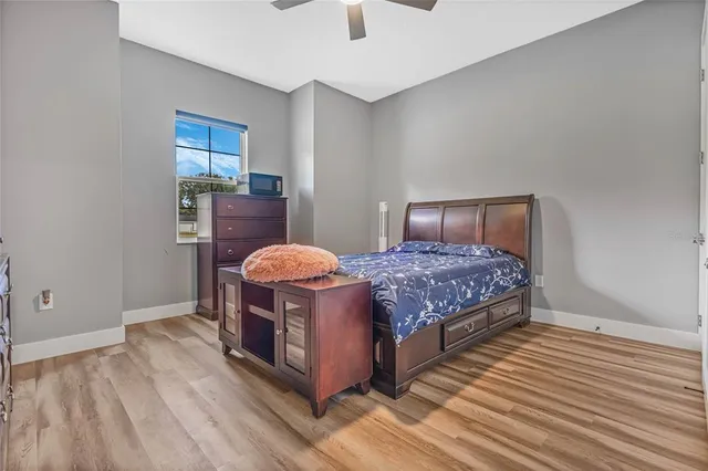 a bedroom with a bed and painting on the wall