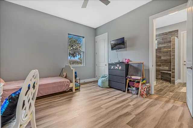 a living room with furniture a flat screen tv and a large window