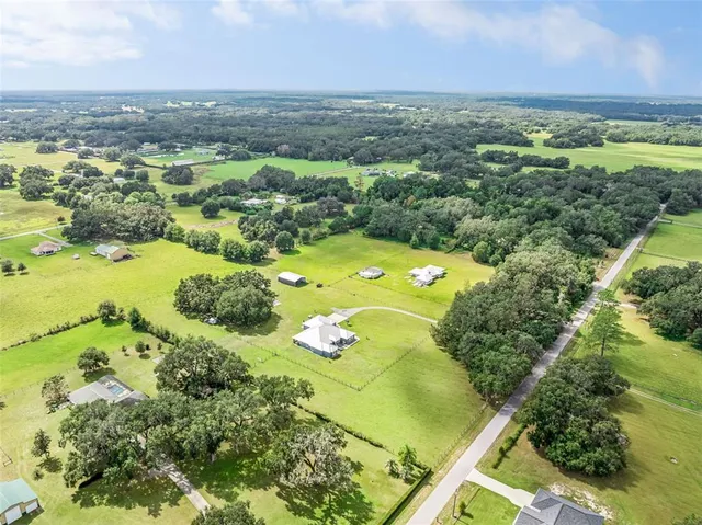 an aerial view of residential house with pool yard and outdoor seating