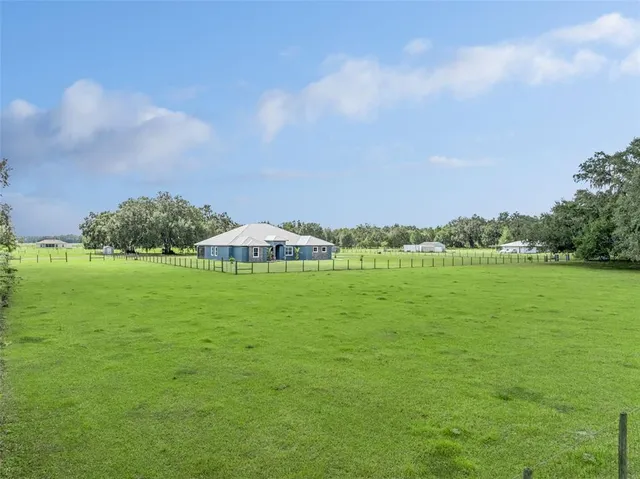 a living room with lots of furniture and a wooden floor