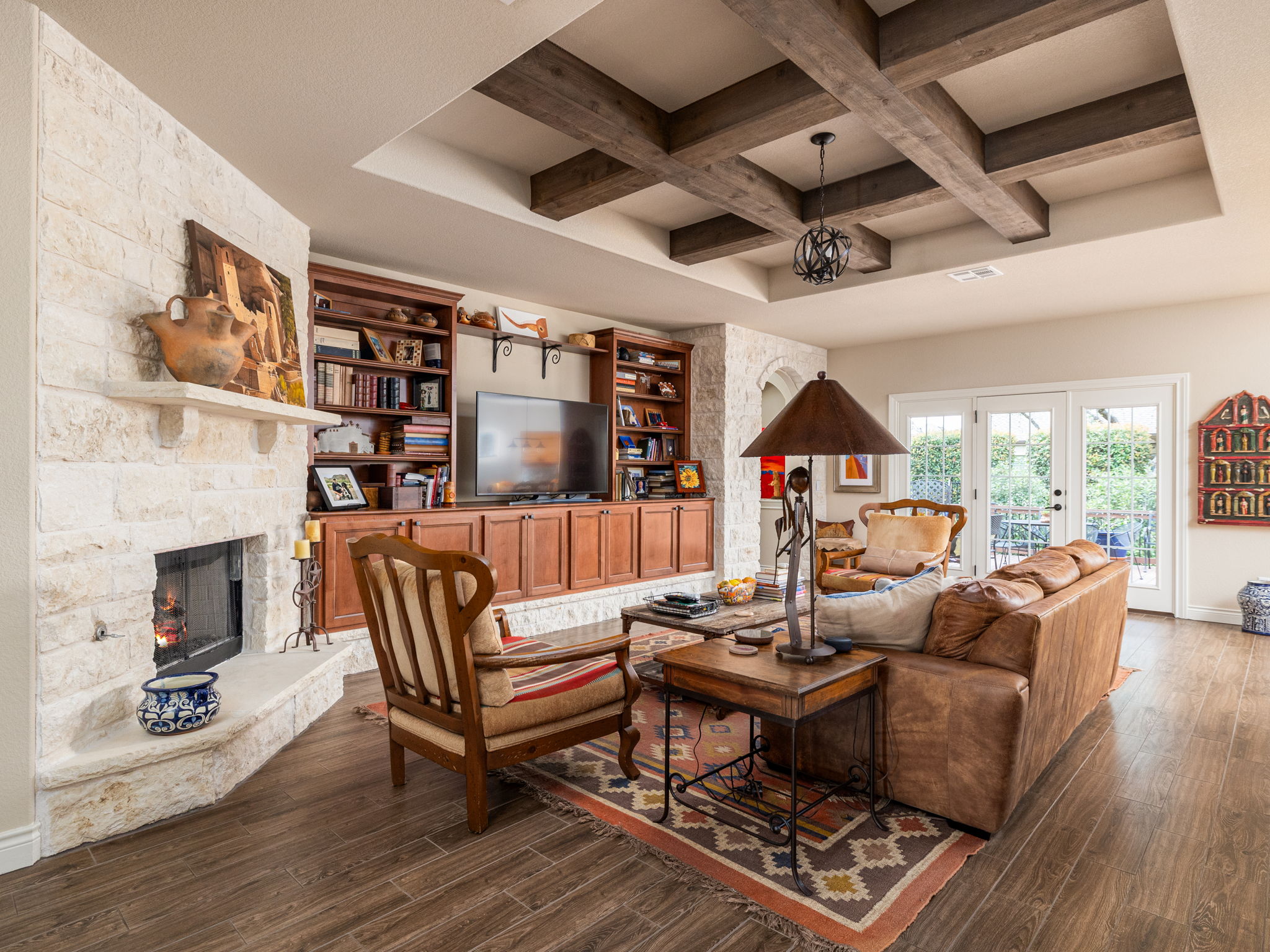 817 Sierra Blanco Loop Georgetown, TX 78633 - Photo 1 of 1 Living area with a stone fireplace, beamed ceiling, wood flooring, and French doors