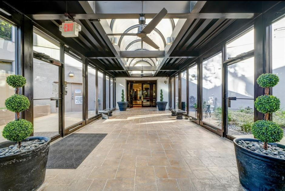 3525 Sage Road, Unit 913 Houston, TX 77056 - Photo 22 of 22 a building with potted plants in front of it