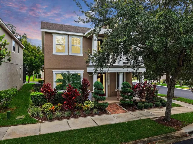 a front view of a house with a garden