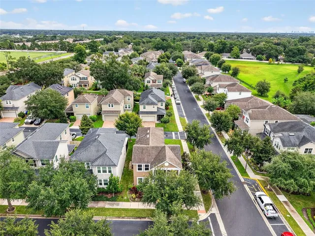 an aerial view of house with yard and lake view