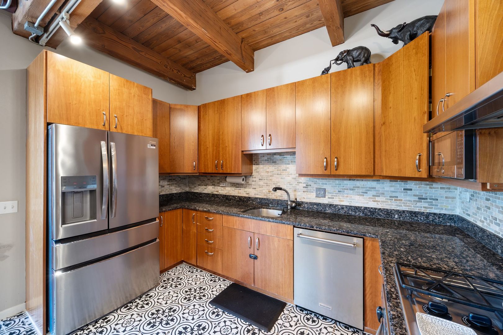 2222 North Racine Avenue, Unit 12 Chicago, IL 60614 - Photo 15 of 37 a kitchen with stainless steel appliances granite countertop a sink stove and refrigerator