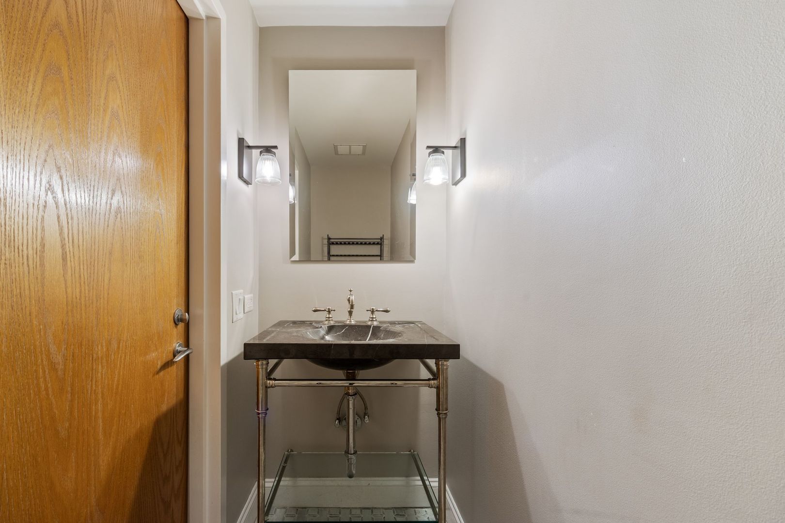 2222 North Racine Avenue, Unit 12 Chicago, IL 60614 - Photo 16 of 37 a bathroom with a sink and a mirror