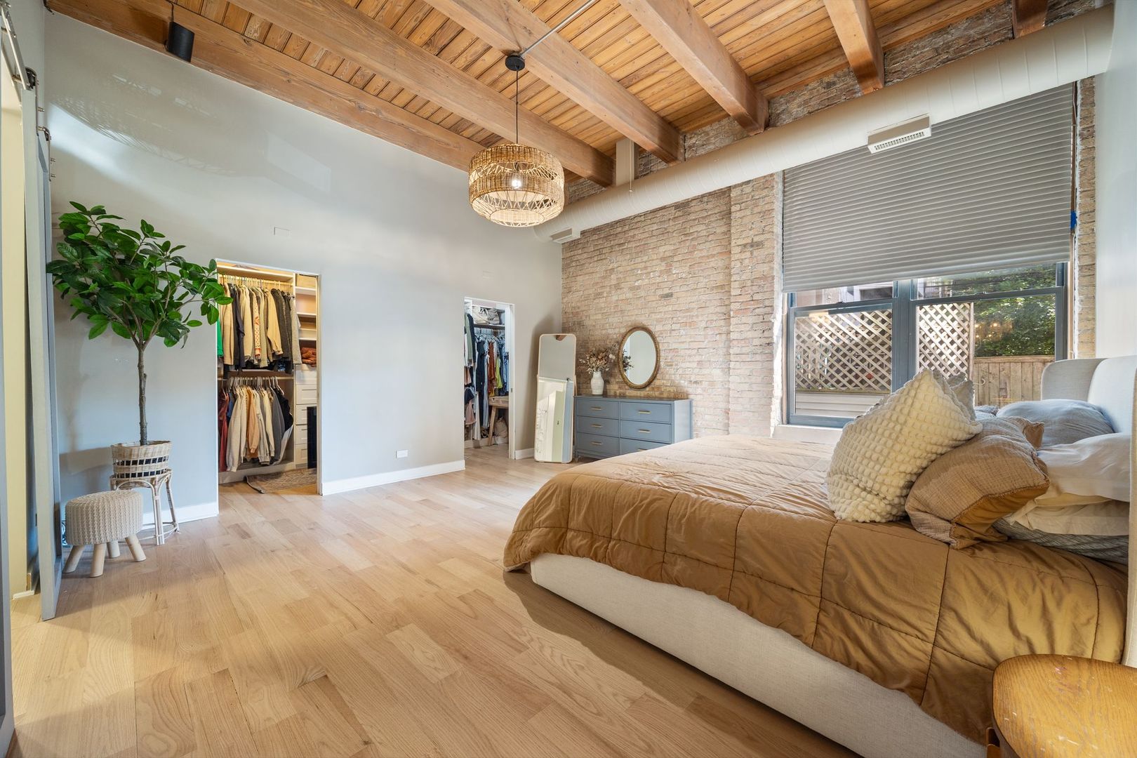 2222 North Racine Avenue, Unit 12 Chicago, IL 60614 - Photo 18 of 37 a bedroom with a large bed and a chandelier