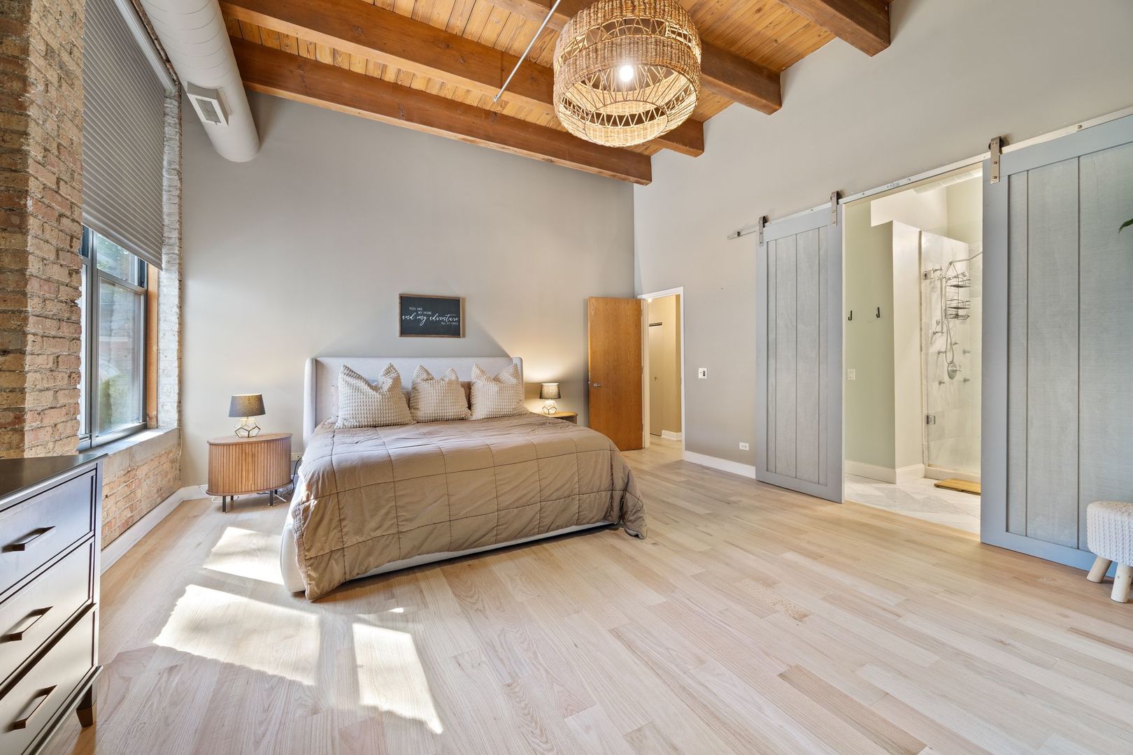 2222 North Racine Avenue, Unit 12 Chicago, IL 60614 - Photo 19 of 37 a bedroom with a bed and dresser with wooden floor