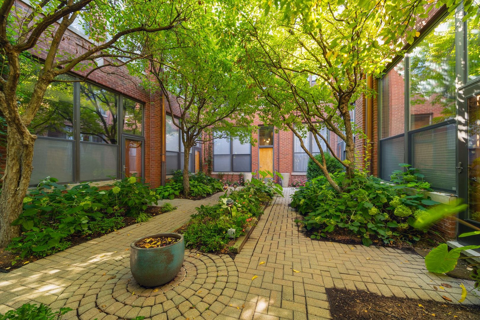 2222 North Racine Avenue, Unit 12 Chicago, IL 60614 - Photo 3 of 37 a view of a backyard with potted plants and large trees