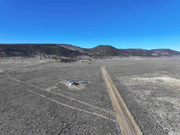 a living room with lots of furniture and a kitchen view