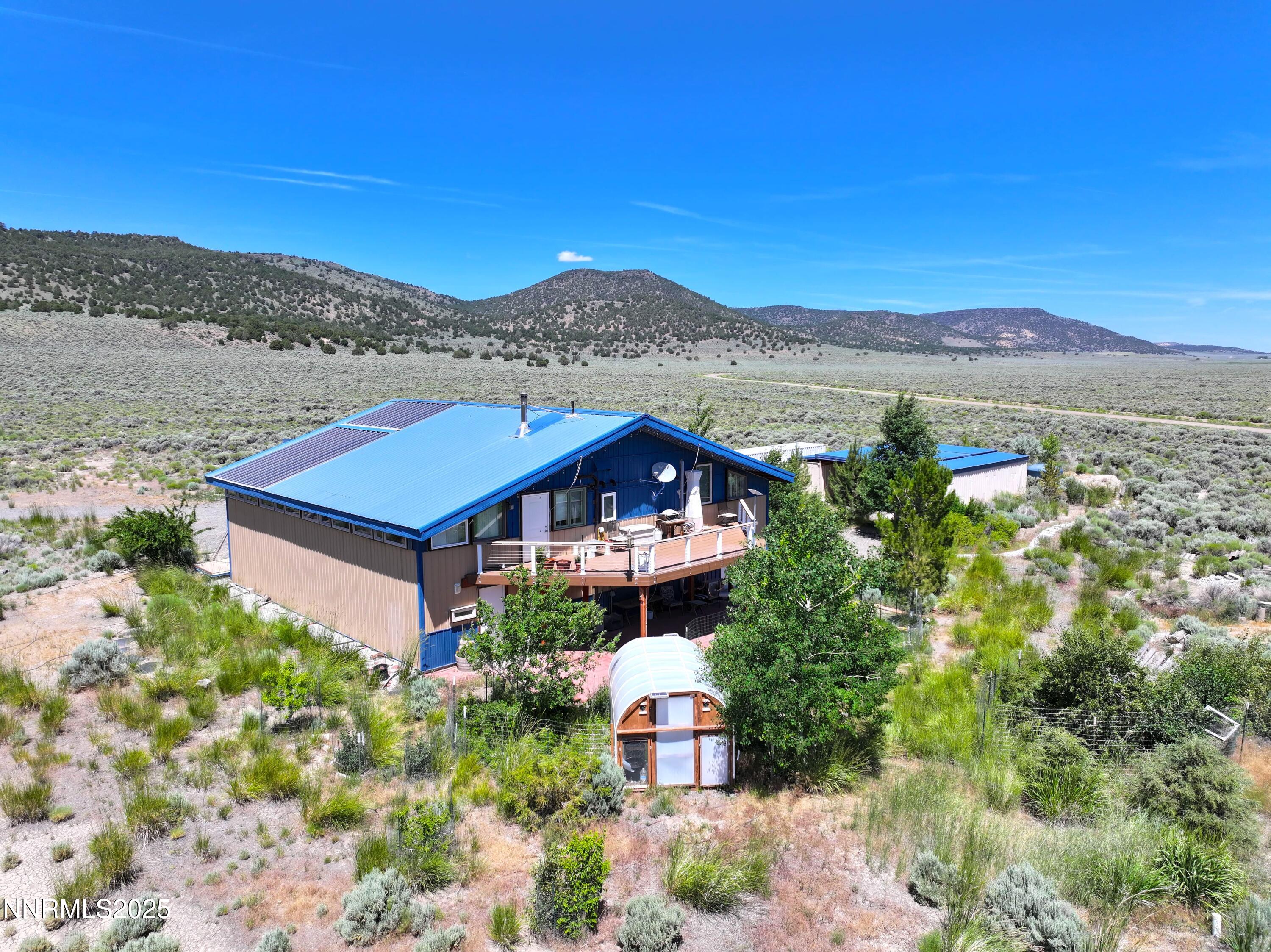 93205 State Route 34 Gerlach, NV 89412 - Photo 3 of 70 a front view of a house with a yard and mountain view in back