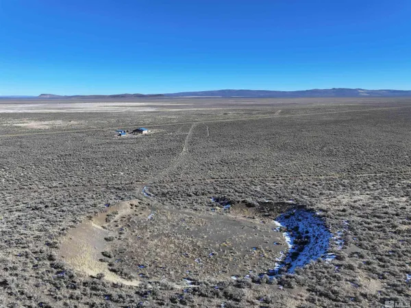a view of a livingroom with furniture and a flat screen tv