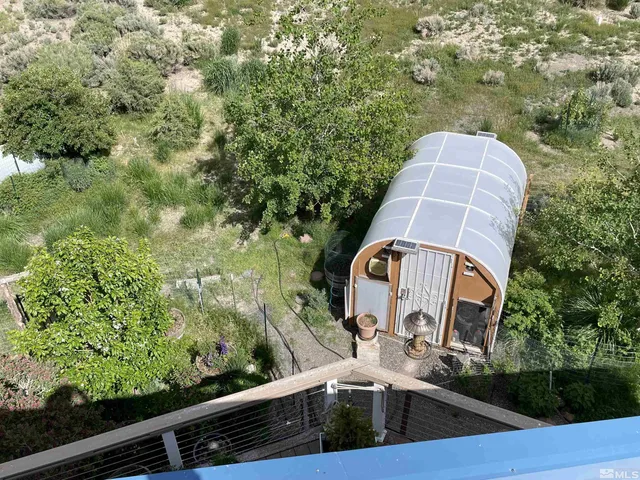 a view of a dry yard with mountains in the background