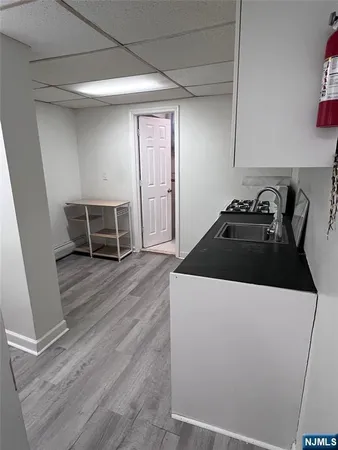 a kitchen with a stove and wooden floor