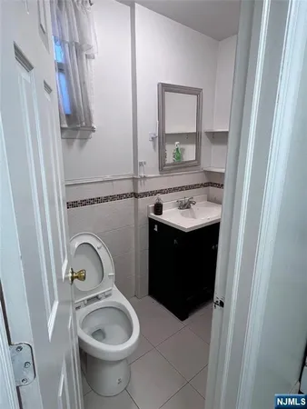a bathroom with a sink toilet and a mirror