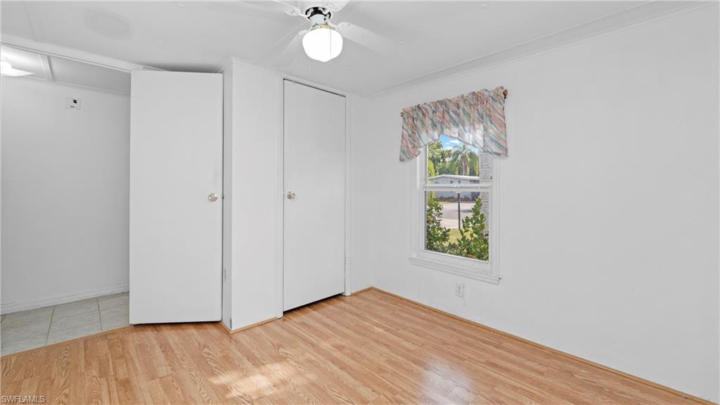 Undisclosed Address Naples, FL 34114 - Photo 11 of 20 wooden floor in an empty room with a window