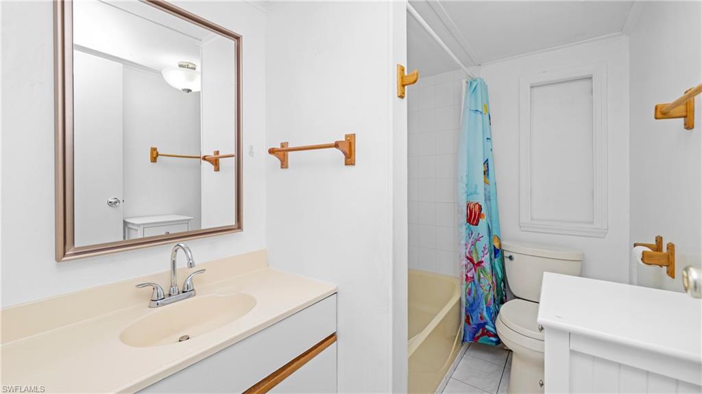 Undisclosed Address Naples, FL 34114 - Photo 13 of 20 a bathroom with a sink a toilet and a mirror