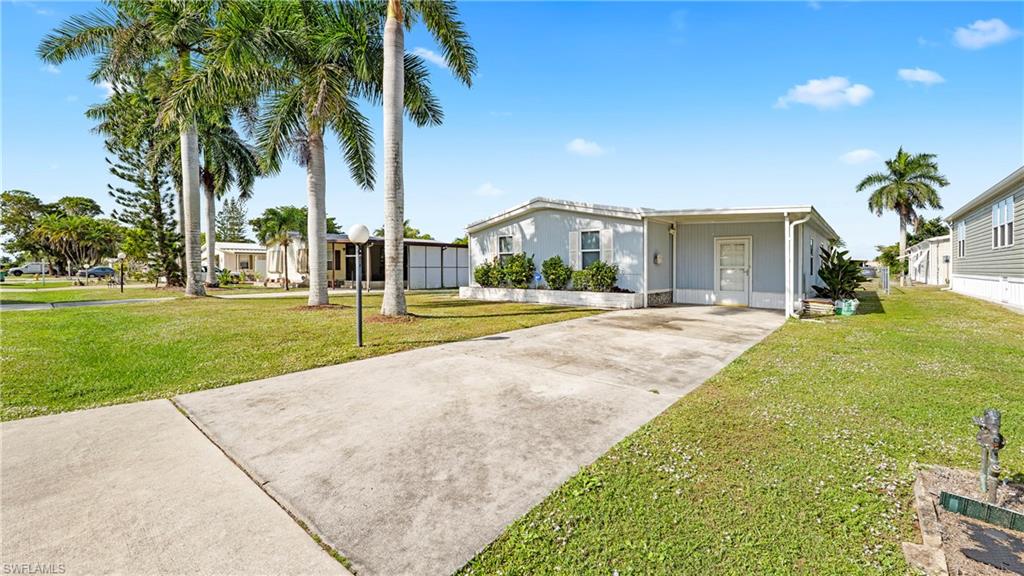 Undisclosed Address Naples, FL 34114 - Photo 17 of 20 a front view of house with yard and green space