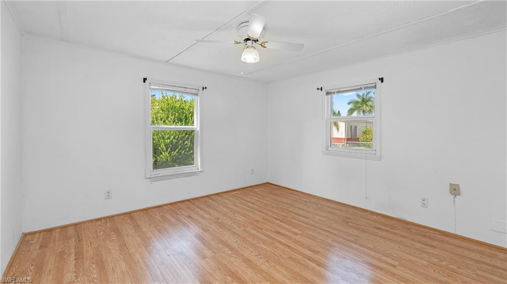 Undisclosed Address Naples, FL 34114 - Photo 8 of 20 wooden floor in an empty room with a window