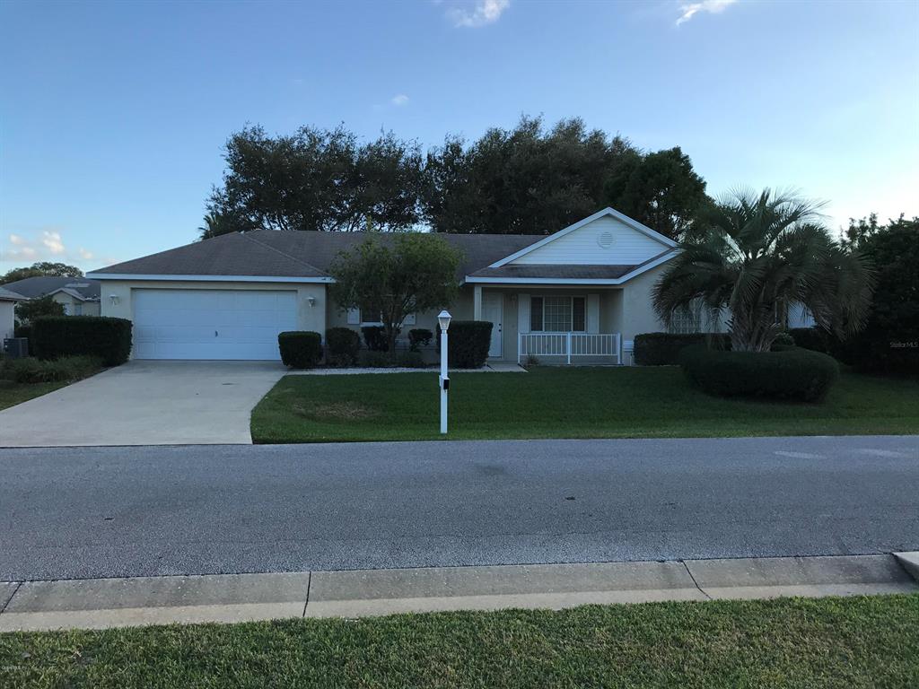 5216 Northwest 21st Loop Ocala, FL 34482 - Photo 1 of 1 a view of a house with a yard and large trees