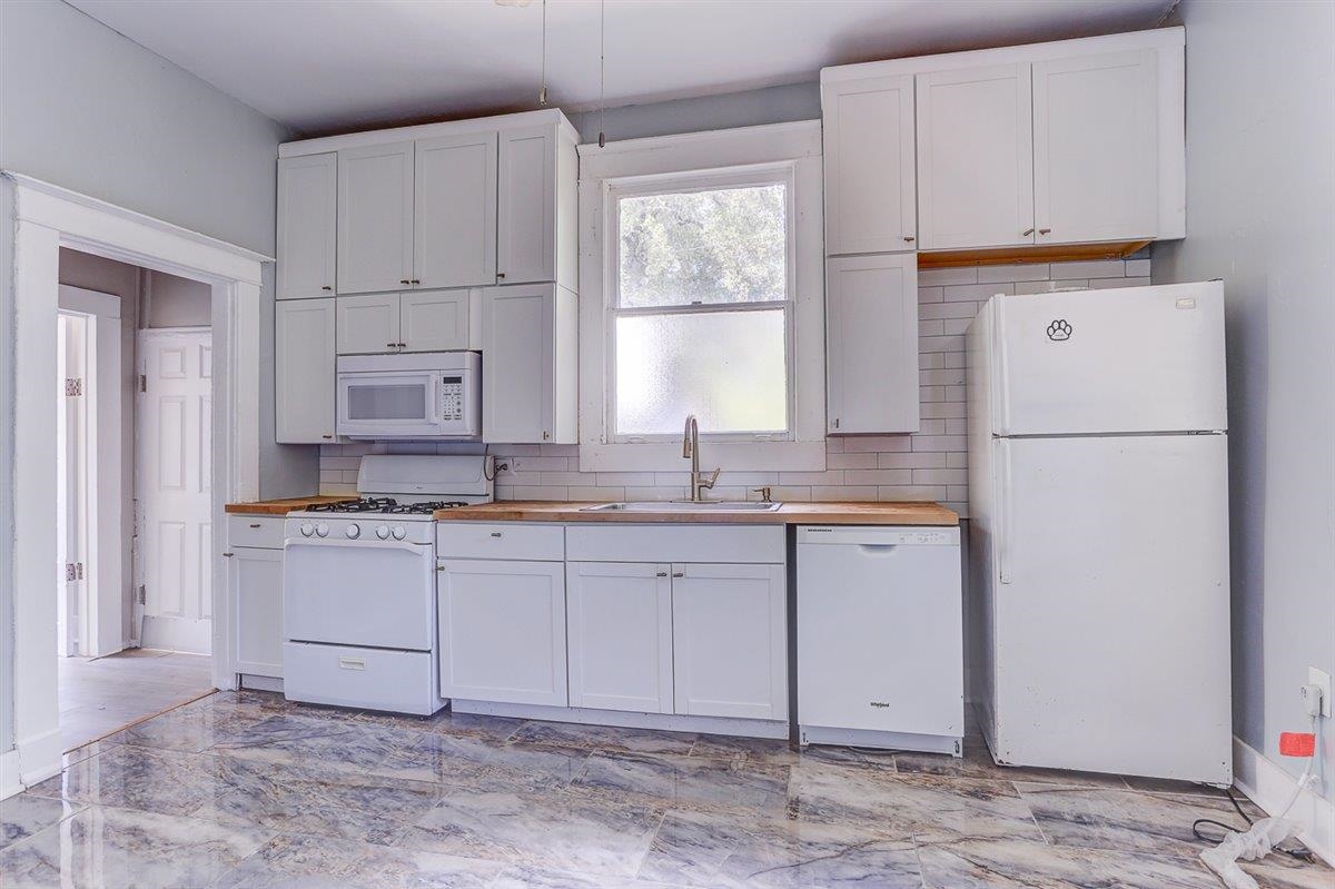 2006 Felix Avenue Memphis, TN 38104 - Photo 12 of 37 a kitchen with a refrigerator sink and cabinets