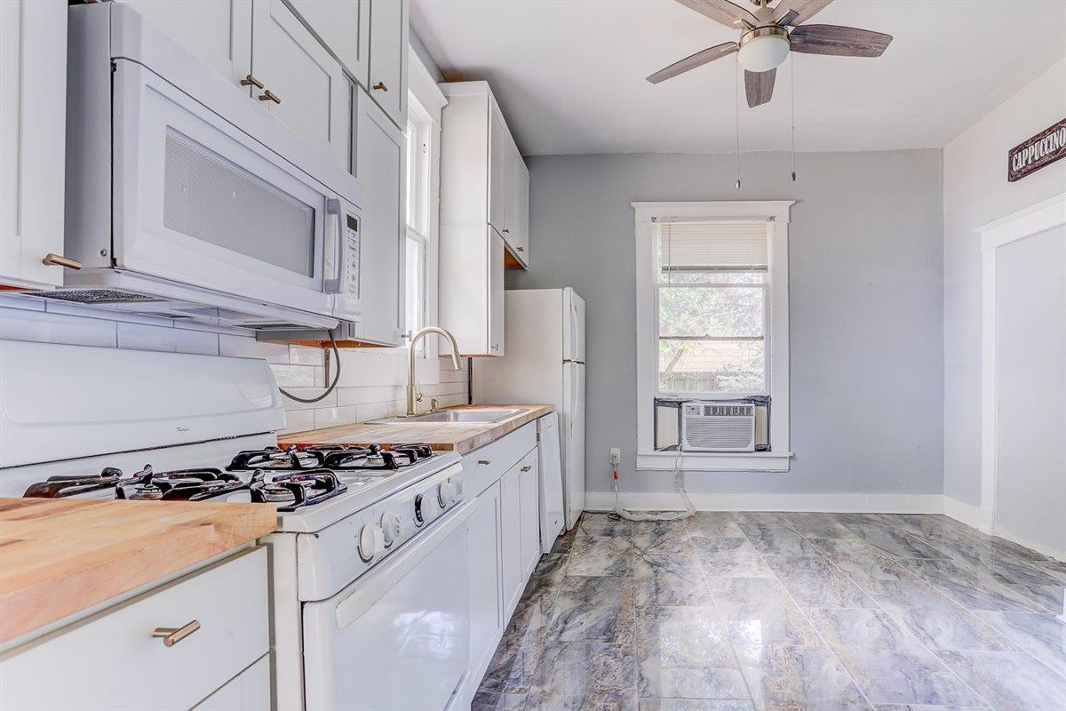2006 Felix Avenue Memphis, TN 38104 - Photo 13 of 37 a kitchen with stainless steel appliances granite countertop a stove a sink and a refrigerator
