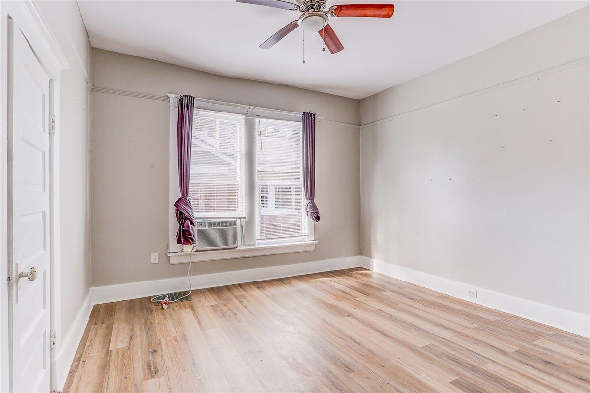 2006 Felix Avenue Memphis, TN 38104 - Photo 17 of 37 a view of an empty room with wooden floor and a window