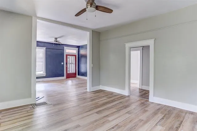 wooden floor in an empty room with a window