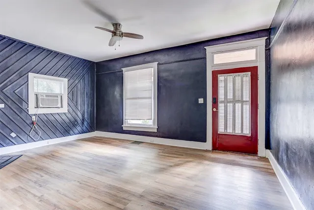 an empty room with windows and closet