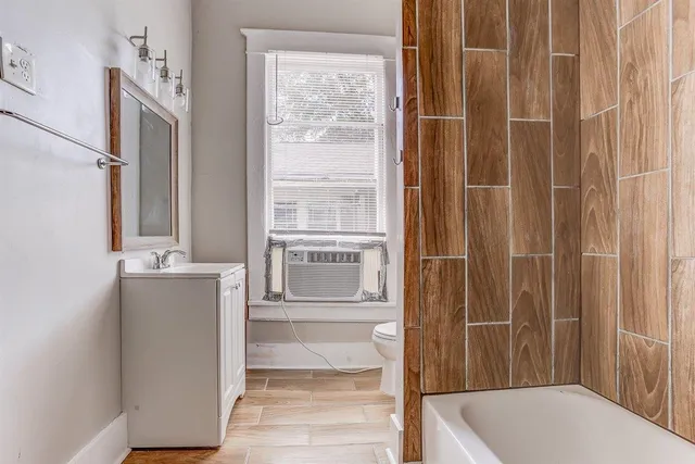 a bathroom with a tub and shower