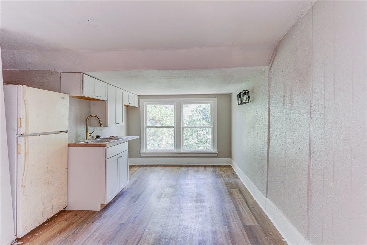 2006 Felix Avenue Memphis, TN 38104 - Photo 27 of 37 a kitchen with a refrigerator a sink and wooden floor