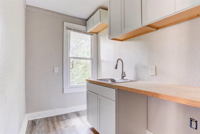a kitchen with a sink cabinets and a window