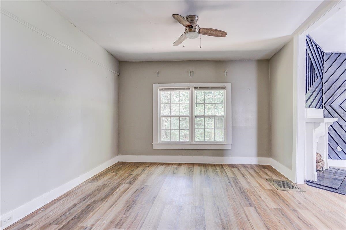 2006 Felix Avenue Memphis, TN 38104 - Photo 5 of 37 a view of an empty room with a window and wooden floor