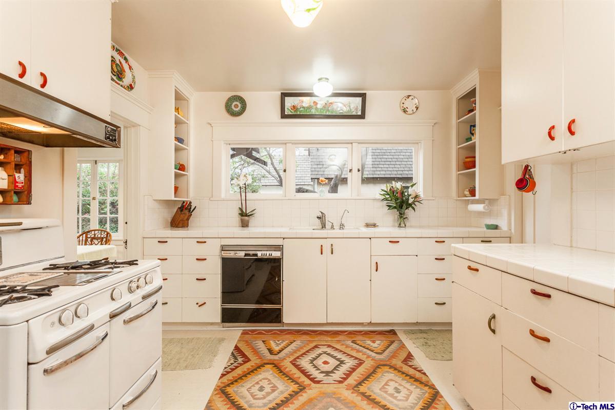 1255 Morada Place Altadena, CA 91001 - Photo 9 of 37 a kitchen with granite countertop a sink stove and cabinets